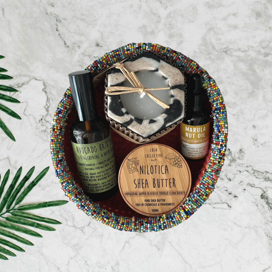 A self care hamper containing shea butter, marula oil, avocado hair oil and a hex candle